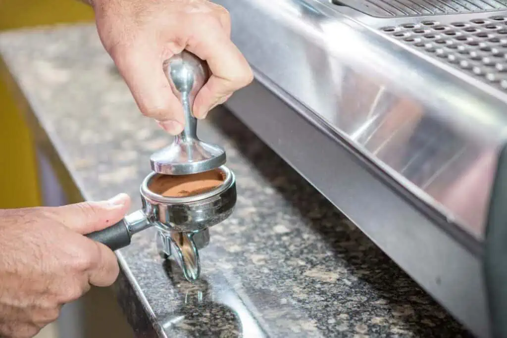 Tamping coffee grounds correctly to avoid watery espresso